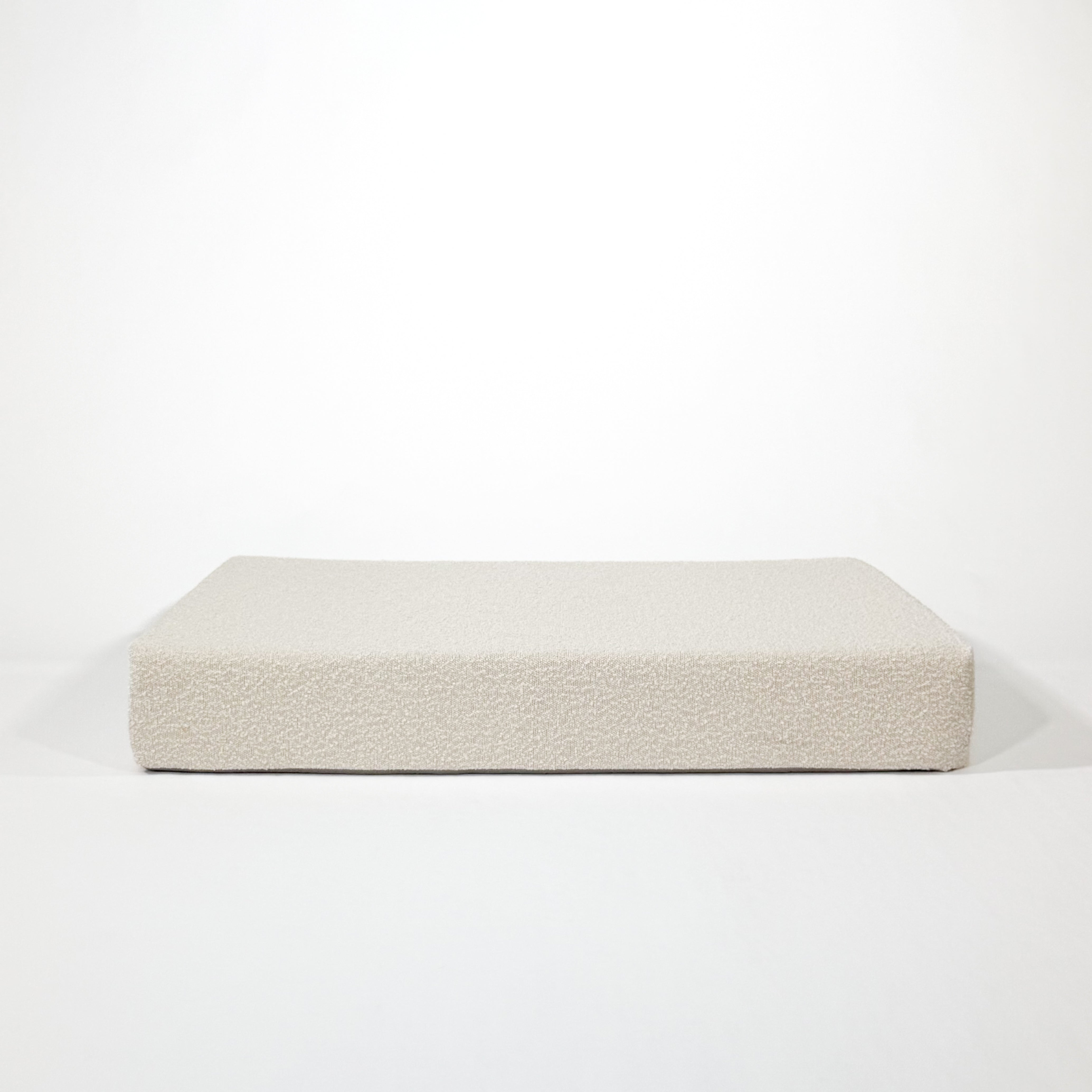Front of cloud colored boucle cushion dog bed.