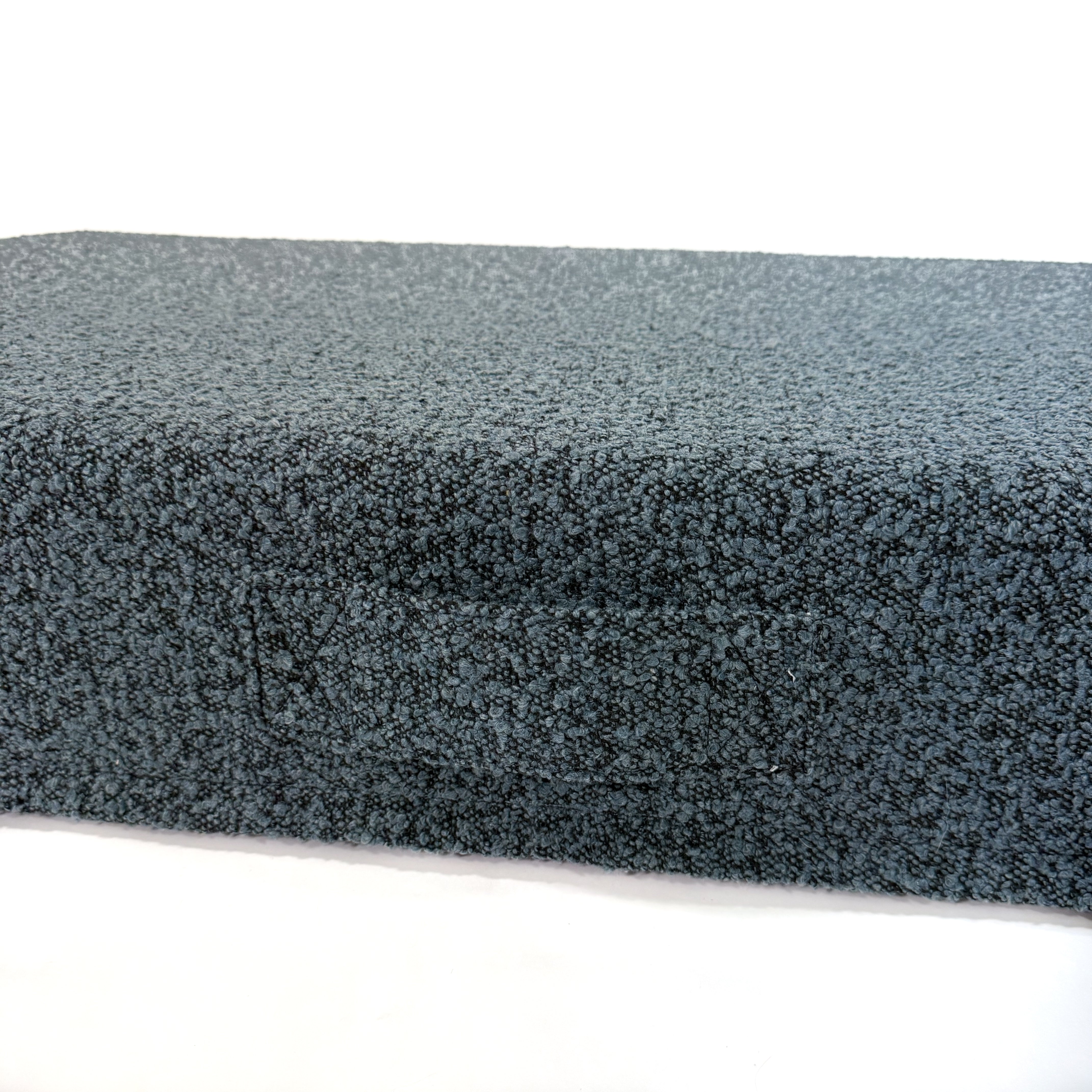 Up close of handle on the ocean blue boucle dog bed.