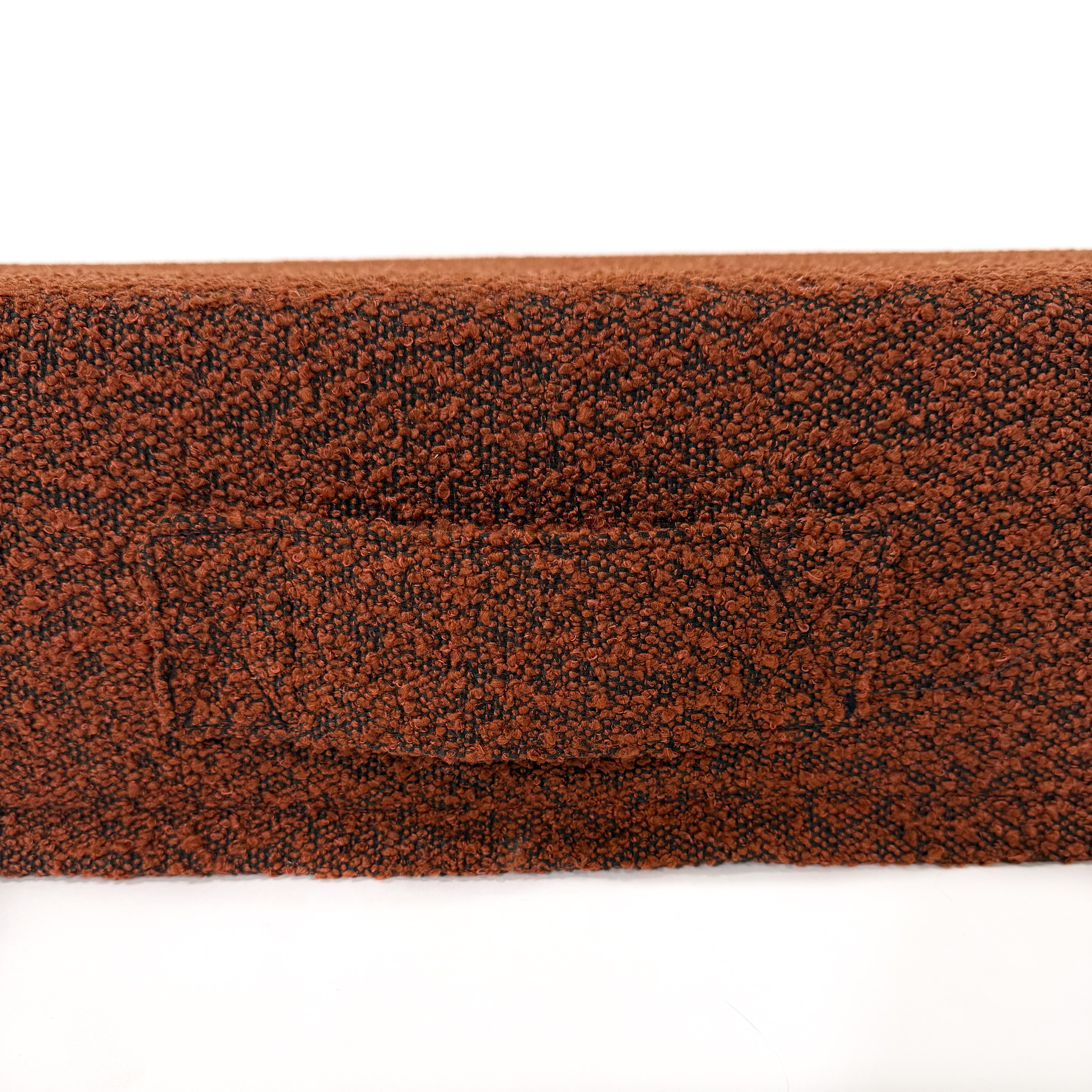 A close up of the pumpkin spice colored dog bed cover with handle against a white background