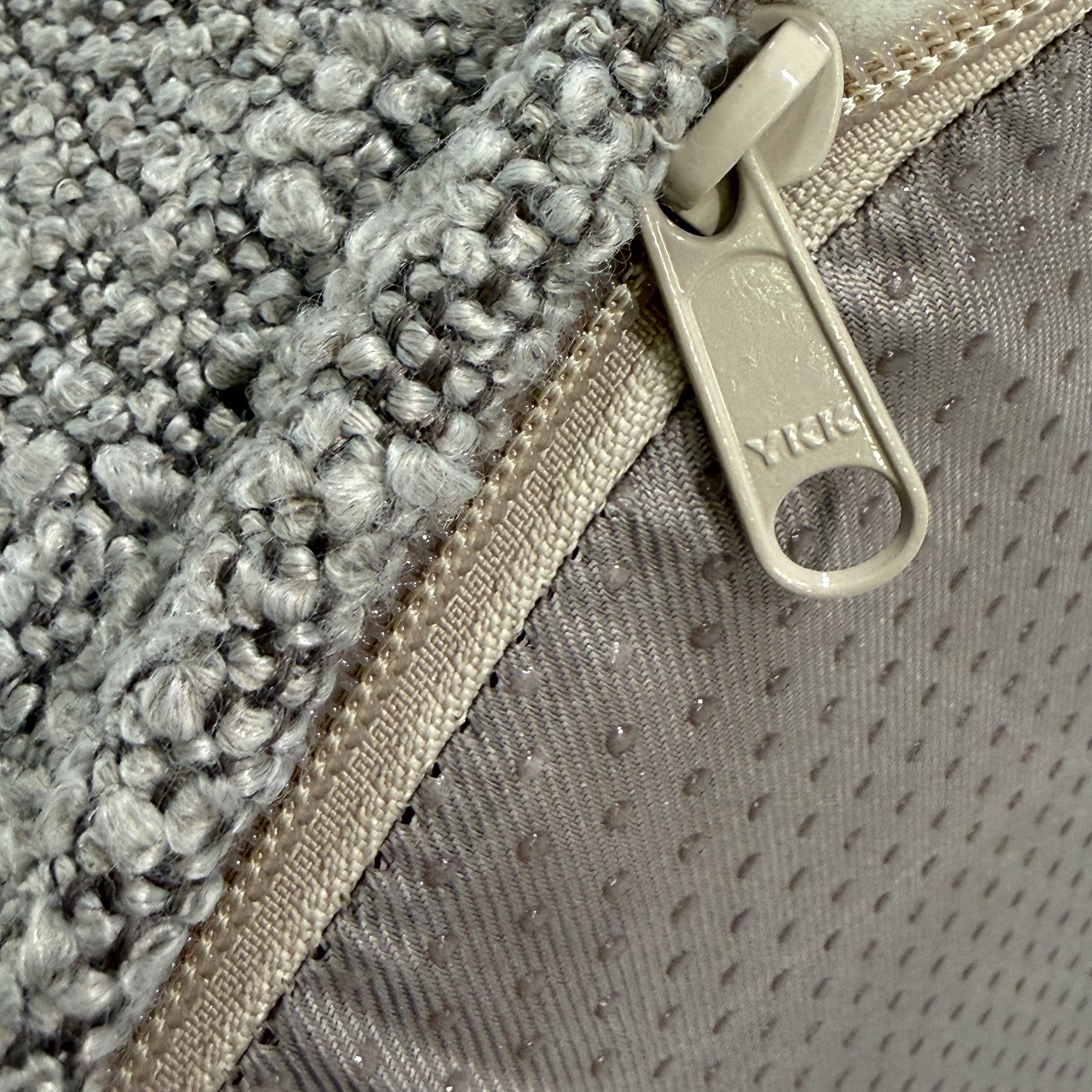 Close up of the YKK zipper on the cushion dog bed.
