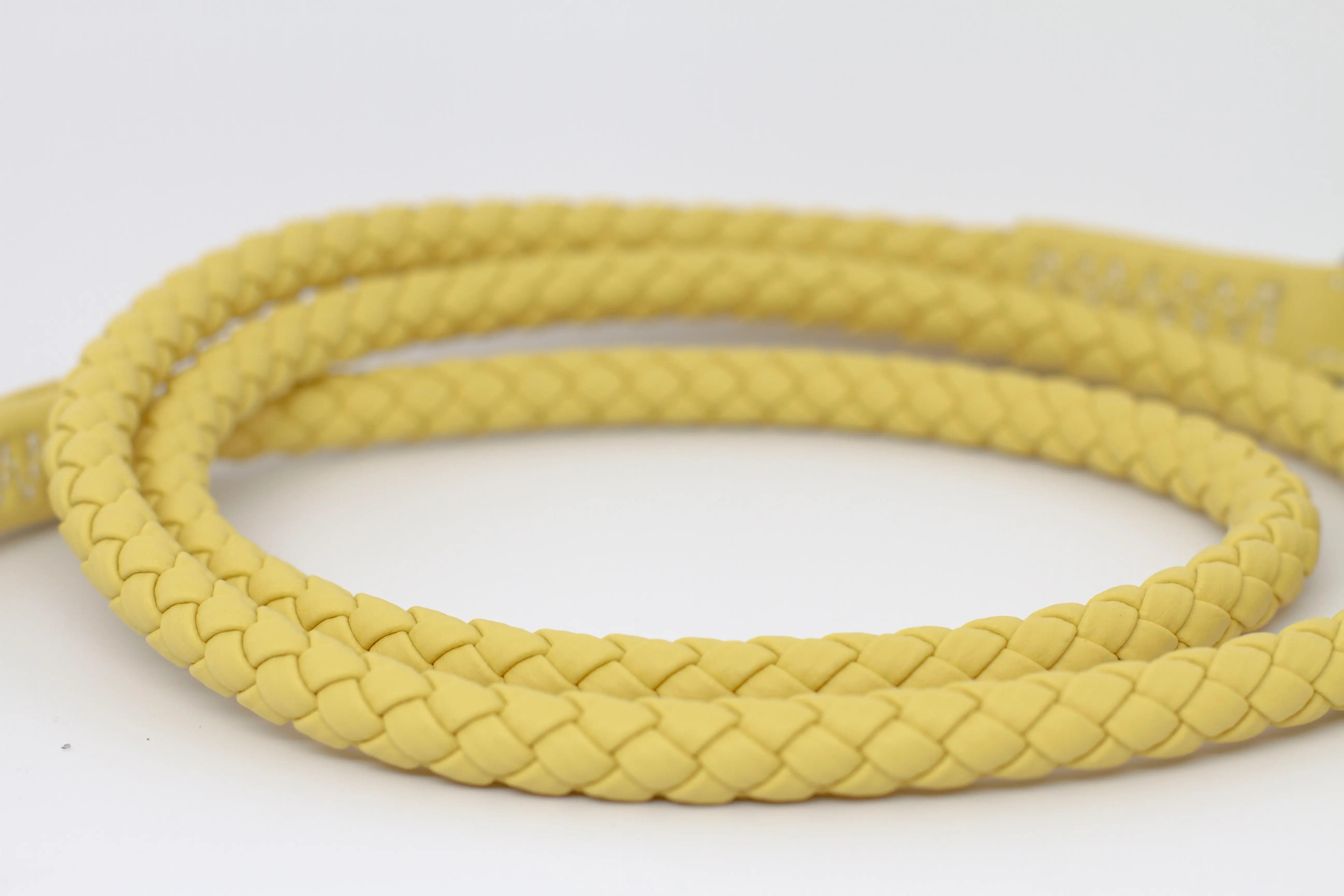 Close up of the braid of waterproof and durable dog leash with marine grade anodized aluminum hardware in the color honey yellow.