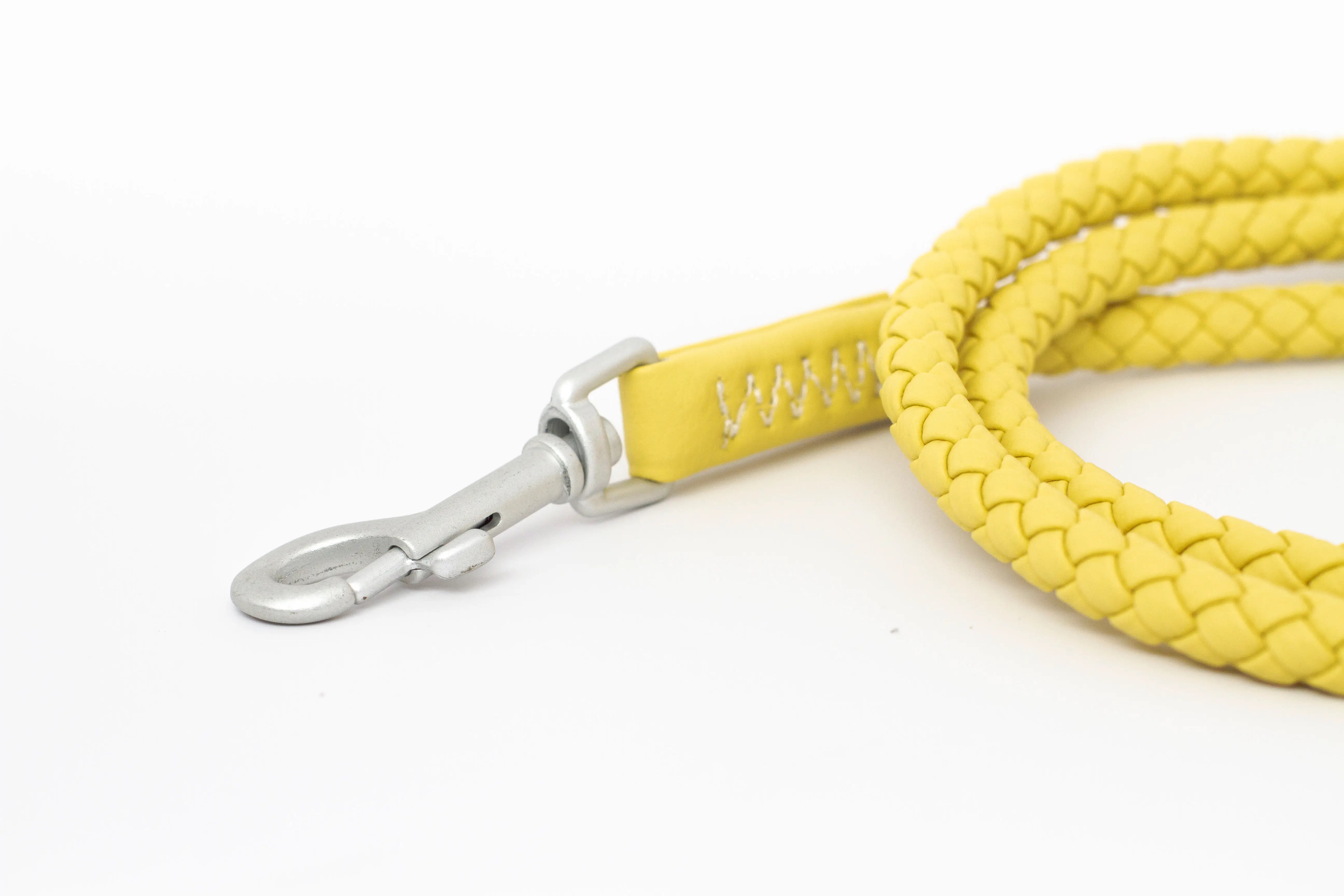 Close up of a waterproof and durable dog leash with marine grade anodized aluminum hardware in the color honey yellow.