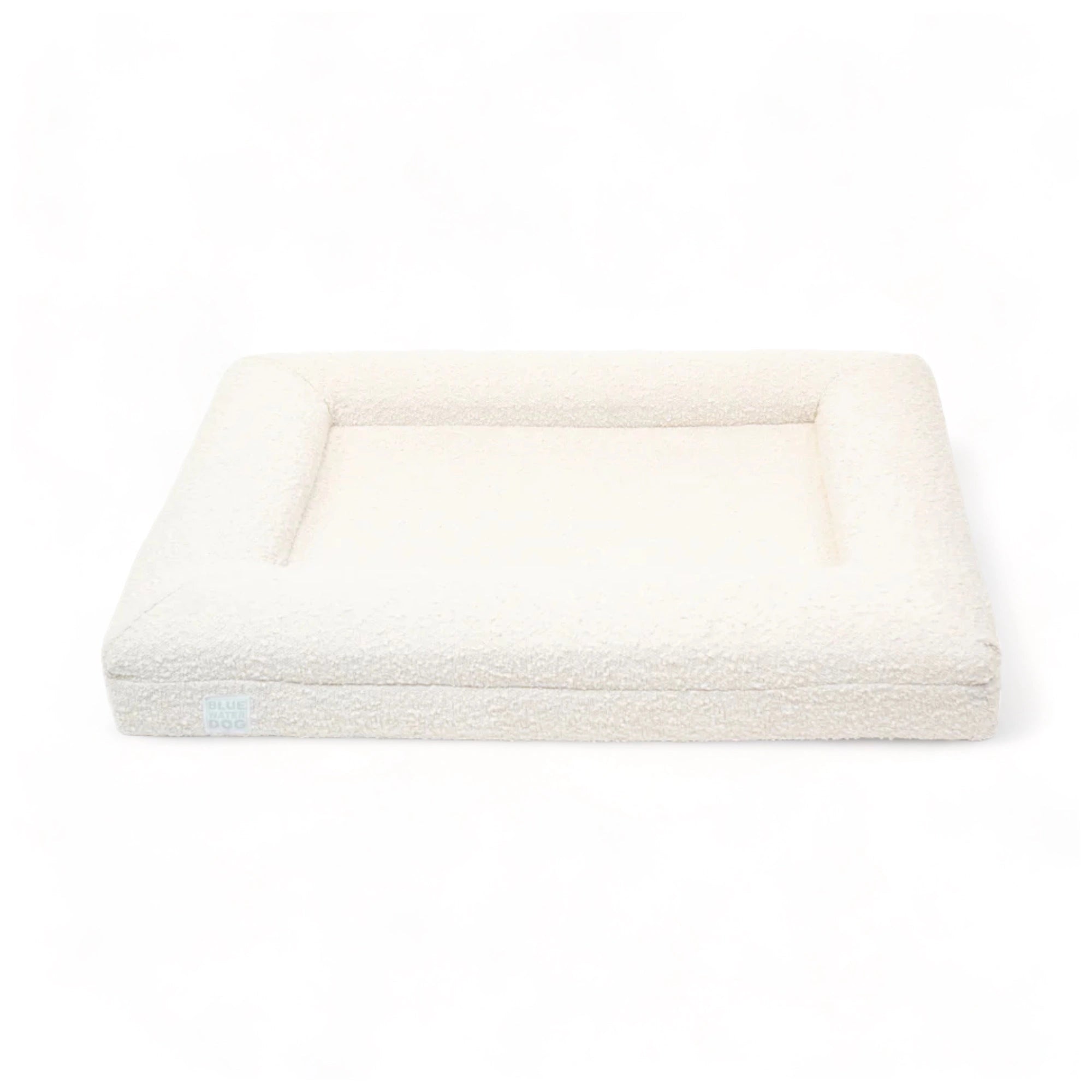 Front of a medium, cloud-colored orthopedic memory foam rectangular boucle dog bed with bolsters