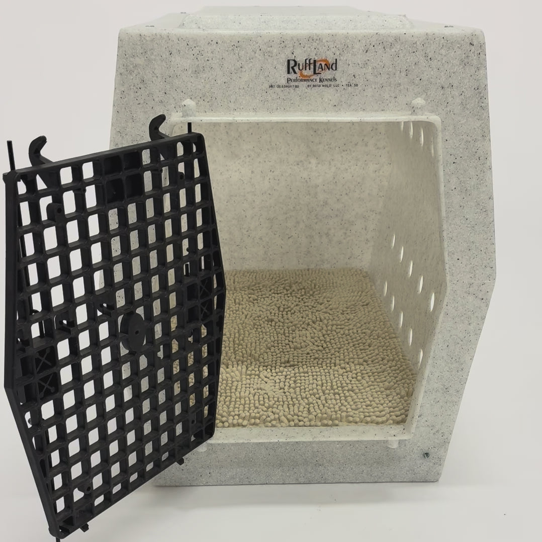 Dog walking into dog crate with crate pad and towel cover.