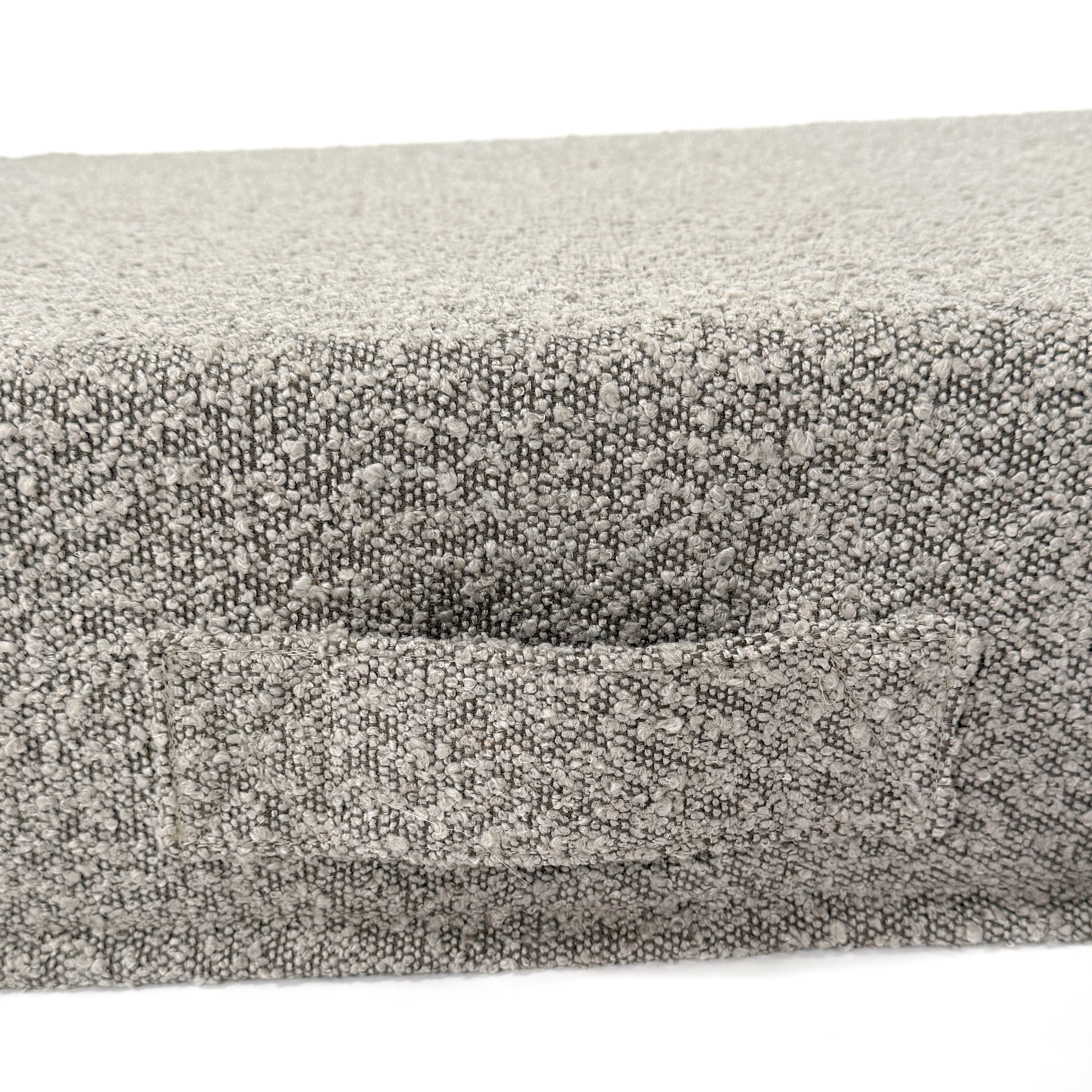 Close up of a handle on a cushion dog bed.