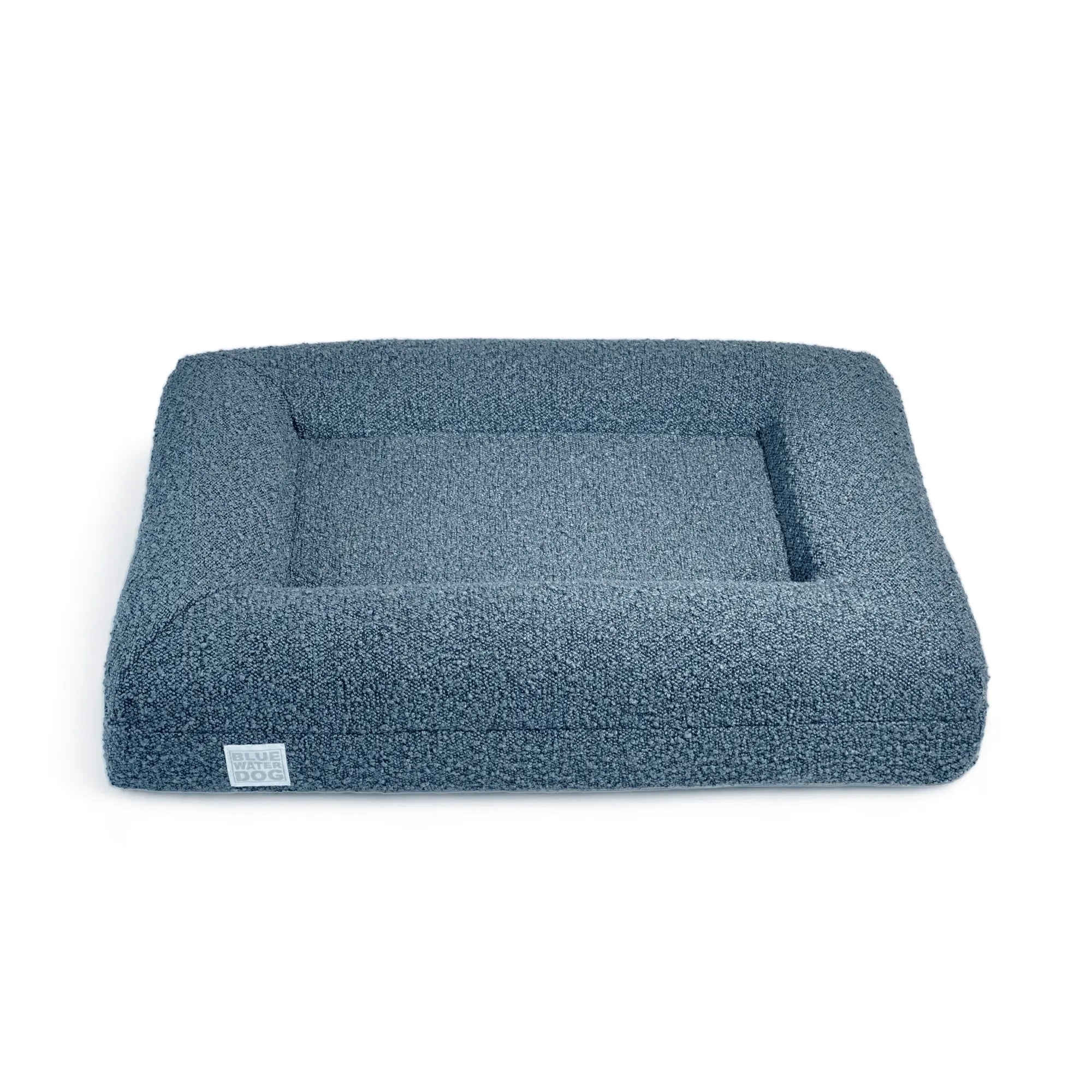 Front of a small, blue-colored orthopedic memory foam rectangular boucle dog bed with bolsters