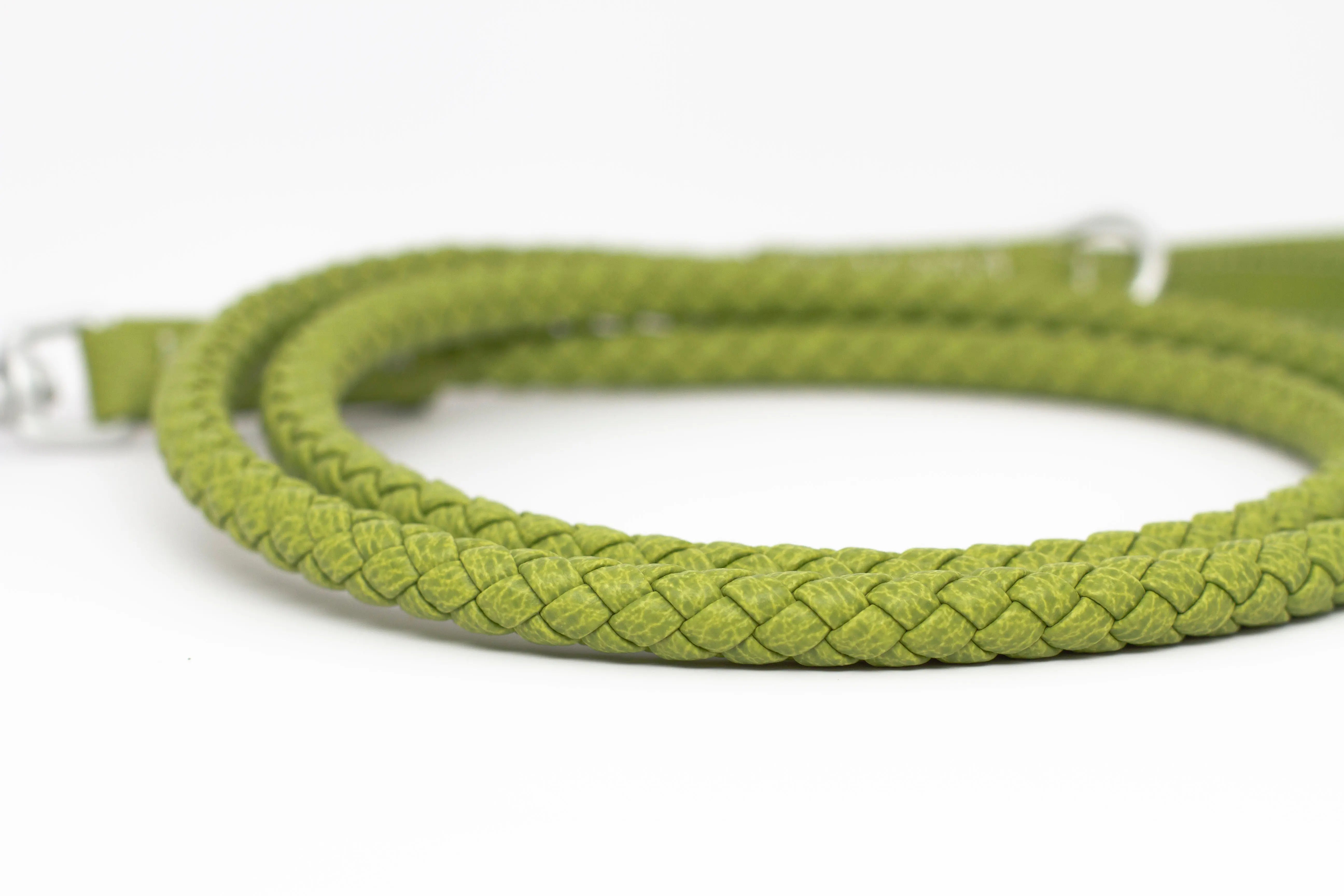 Close up of the braid of waterproof and durable dog leash with marine grade anodized aluminum hardware in the color lime green.
